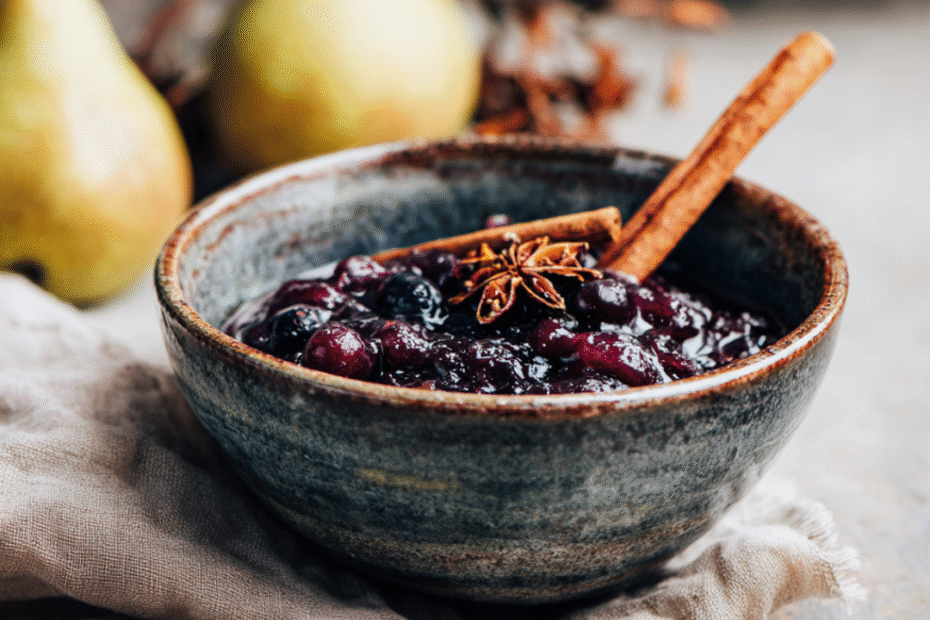Holunder-Birnen-Kompott mit Zimt – herbstlich, aromatisch & wohltuend 1 Herbstliches Holunder-Birnen-Kompott mit Zimtstange im Glas – serviert auf Leinentuch.